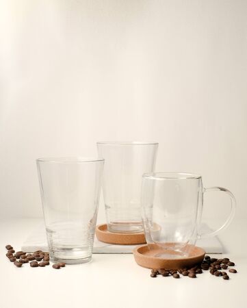 Ice coffee in the glass topped whipping cream with coffee beans. Cold summer drink on wooden background and copy space. Advertising for caramel mocha and chocolate beverage for the cafe.の写真素材