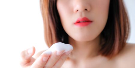 Young beautiful asian woman applying make up. cosmetic beauty conceptの写真素材
