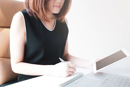 young asian woman work and e learning . online working business in office. blog.の写真素材