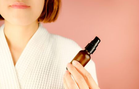 beauty and fashion pink background.woman with cosmetic and skincare product . facial cream serum and moisturizer spa content. asian people with makeup.の写真素材