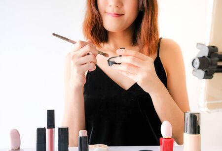 Young beautiful asian woman applying make up. cosmetic beauty conceptの写真素材
