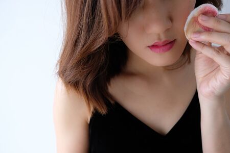 Young beautiful woman applying make up.の写真素材