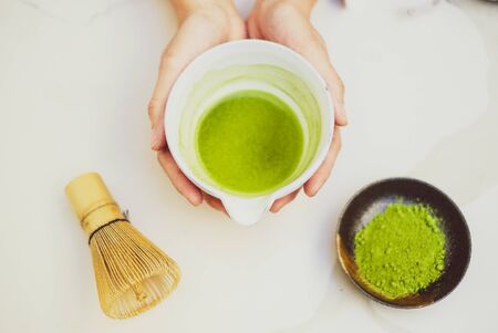 matcha green tea and bamboo whisk on white background. tradition japanese tea ceremonial.の写真素材
