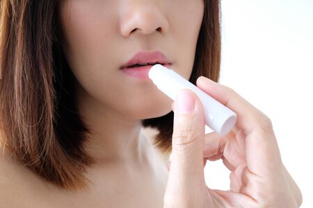 Young beautiful woman applying make up.の写真素材