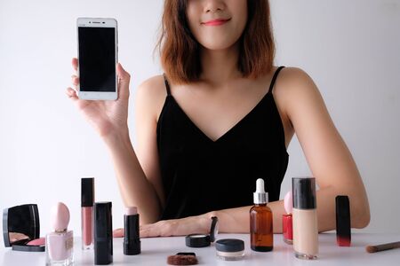 Young beautiful woman applying make up.の写真素材