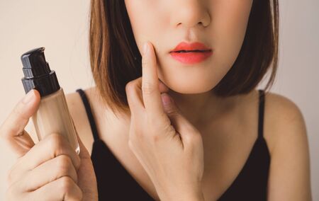 Young beautiful asian woman applying make up. cosmetic beauty conceptの写真素材