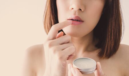Young beautiful asian woman applying make up. cosmetic beauty conceptの写真素材