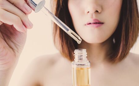 Young beautiful asian woman applying make up. cosmetic beauty conceptの写真素材