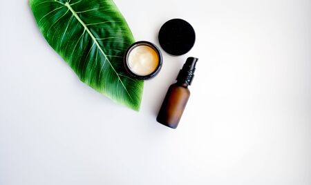 Beauty cosmetic skincare background .Products with flower ,leaves on table top view, flat lay.minimal modernの写真素材
