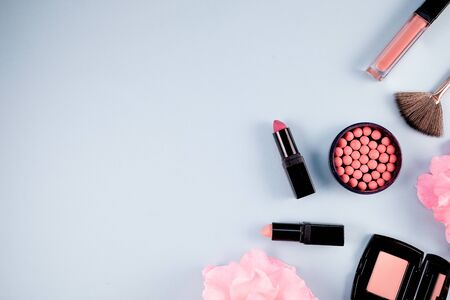 Beauty background makeup cosmetic product,with green leaf and pink rose blossom on purple spring background. woman mother day concept. flatlay topviewの写真素材