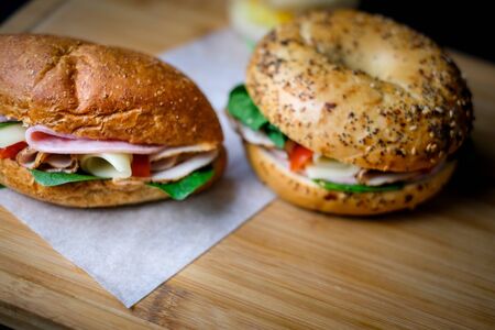 Delicious classic blt sandwiches with ham, cheese, bacon, tomatoes. Breakfast and fast food meal. on isolated black background wooden and text copy space.の写真素材