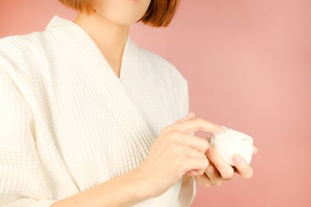 beauty and fashion pink background.woman with cosmetic and skincare product . facial cream serum and moisturizer spa content. asian people with makeup.の写真素材