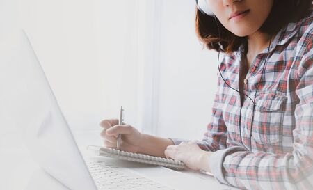 young asian woman work and e learning . online working business in office. blog.の写真素材