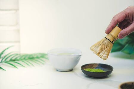 matcha green tea and bamboo whisk on white background. tradition japanese tea ceremonial.の写真素材