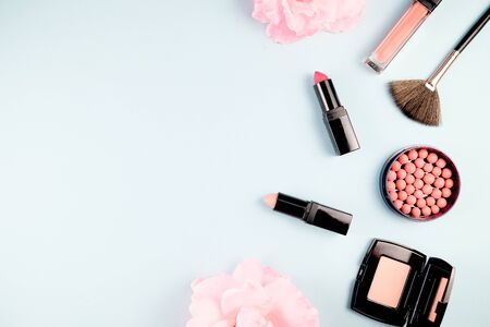 Beauty background makeup cosmetic product,with green leaf and pink rose blossom on purple spring background. woman mother day concept. flatlay topviewの写真素材