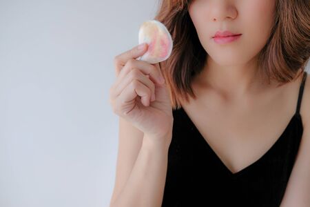 Young beautiful woman applying make up.の写真素材