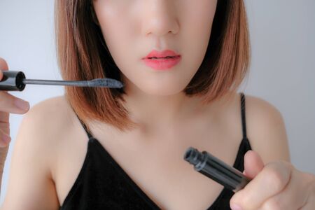 Young beautiful woman applying make up.の写真素材