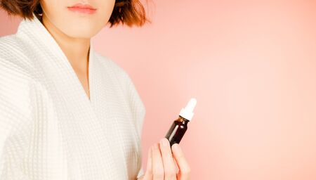 beauty and fashion pink background.woman with cosmetic and skincare product . facial cream serum and moisturizer spa content. asian people with makeup.の写真素材