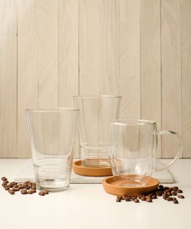 Ice coffee in the glass topped whipping cream with coffee beans. Cold summer drink on wooden background and copy space. Advertising for caramel mocha and chocolate beverage for the cafe.の写真素材