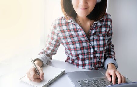 young asian woman work and e learning . online working business in office. blog.の写真素材
