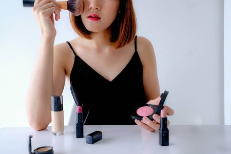 Young asian beauty blogger influencer show make up tutorial .cosmetic skincare concept for social media.の写真素材