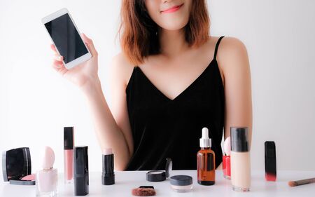 Young beautiful woman applying make up.の写真素材