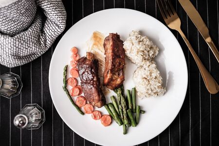healthy eating . diet food dinner dish. pork ribs and green bean, carrot , quinoa.