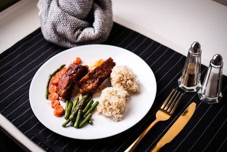 healthy eating. diet food dinner dish. pork ribs and green bean, carrot, quinoa.の写真素材
