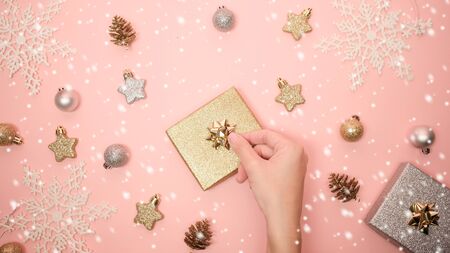 2020 Christmas and new year background banner with the beautiful decor open gift for holiday in winter. On bright pink, golden and silver color theme with snow flake. top view with copy space.の写真素材