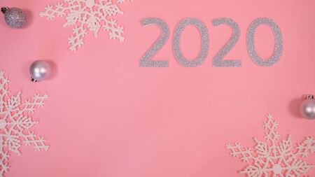 2020 Christmas and new year background banner with the beautiful decor gift for holiday in winter. On bright pink, golden and silver color theme with snow flake. top view with copy space.の写真素材