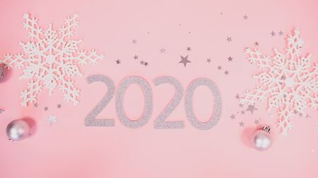 2020 Christmas and new year background banner with the beautiful decor gift for holiday in winter. On bright pink, golden and silver color theme with snow flake. top view with copy space.の写真素材