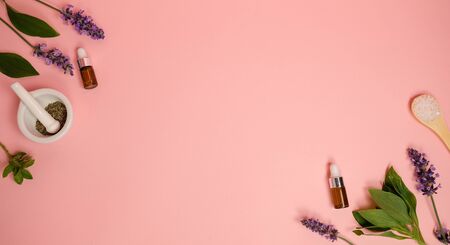 skin care product on pink flat lay backgroung . organic beauty essential oil with herbal and lavender.aromatheraphy for wellness and sp concept.の写真素材