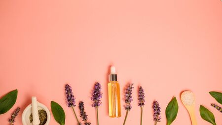 skin care product on pink flat lay backgroung . organic beauty essential oil with herbal and lavender.aromatheraphy for wellness and sp concept.の写真素材