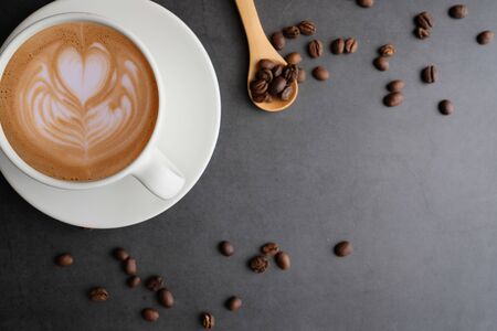 Coffee cup and beans top view with copyspace . flat lay latte for menu, background, banner and advertisement. brew caffeine drink and modern style.の写真素材