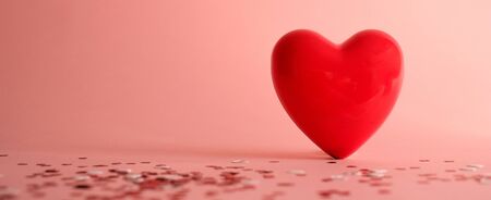 Valentine's Day background . red gloss heart with confetti on pink pastel background with copy space. wedding wallpaper.の写真素材