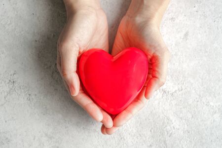 hand carrying heart .love and cardio health concept.valentine and wedding theme.の写真素材