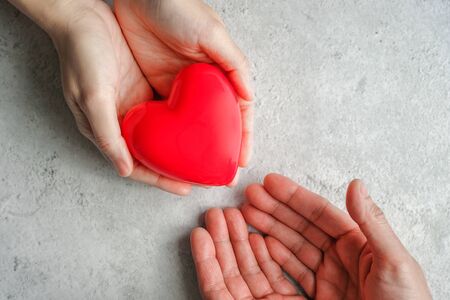 hand carrying heart .love and cardio health concept.valentine and wedding theme.の写真素材