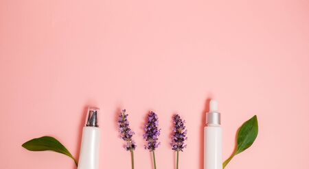 skin care product on pink flat lay backgroung . organic beauty essential oil with herbal and lavender.aromatheraphy for wellness and sp concept.の写真素材