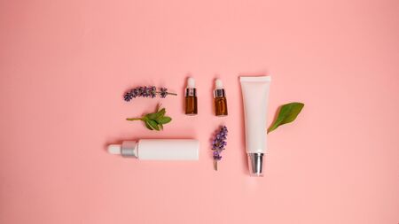 skin care product on pink flat lay background . organic beauty essential oil with herbal and lavender. aromatherapy for wellness and spa concept.の写真素材