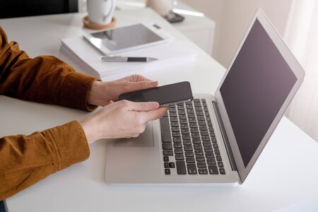 asian adult entrepreneur work on laptop and mobile phone with paperwork in the smart officeの写真素材