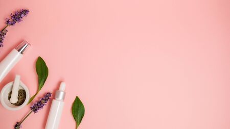 skin care product on pink flat lay background . organic beauty essential oil with herbal and lavender.aromatherapy for wellness and spa concept.の写真素材