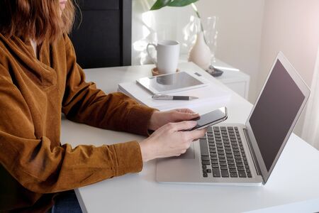 asian adult entrepreneur work on laptop and mobile phone with paperwork in the smart office.の写真素材