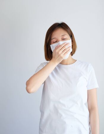 woman wearing mask and cough get sick from corona virus, covid19, flu symptom .の写真素材