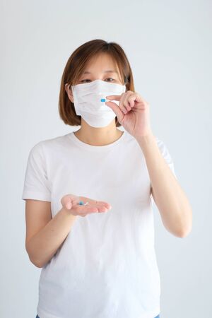 woman taking medicine to treatment from flu, corona virus,covid19.の写真素材