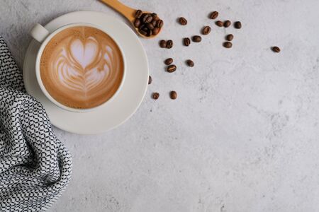 hot coffee with latte art on white marble background with the bean and decorative flat lay style.の写真素材