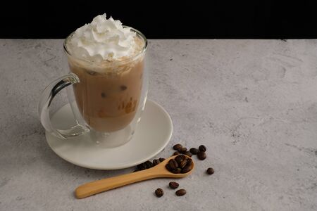 iced coffee with whipping cream and bean in the insulated glass mug.の写真素材