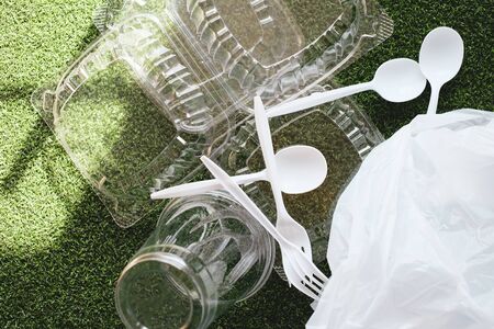 plastic food package and bag on green grass background to recycle and reuse.the environment concern of global warming concern concept.の写真素材