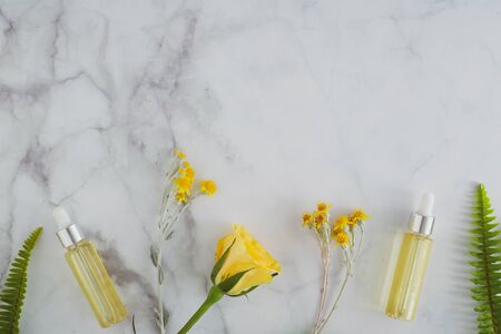 cosmetic skincare essential oil . beauty product on luxury white marble with natural flower for spa concept.の写真素材