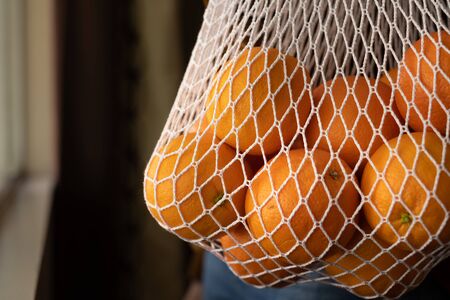 orange in the net bag . minimal lifestyle to save the green earth and environment .の写真素材