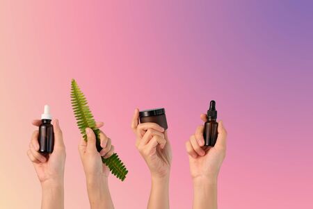 hand hold cosmetic skincare on pink background.beauty banner.の写真素材